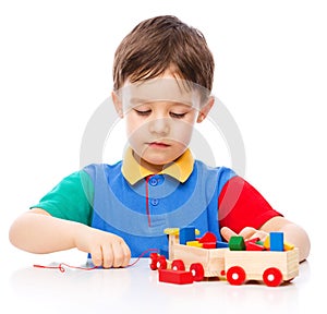 Boy is playing with building blocks