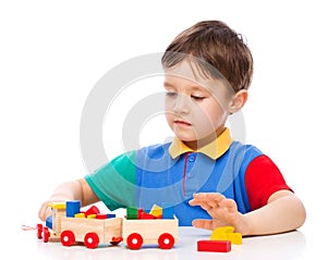 Boy is playing with building blocks