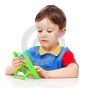 Boy is playing with building blocks