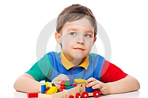 Boy is playing with building blocks