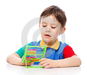 Boy is playing with building blocks