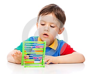 Boy is playing with building blocks