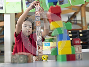 Boy Playing With Building Blocks In Class