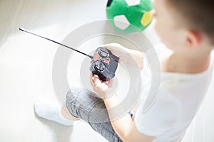 A boy playing with a car remote