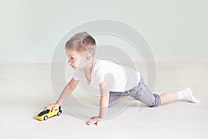 A boy playing with a car remote