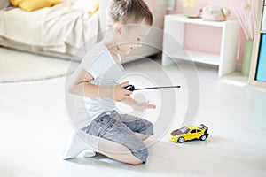 A boy playing with a car remote