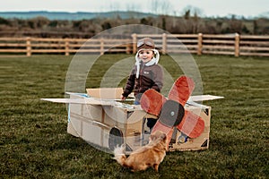 Boy playing with a cardboard plane