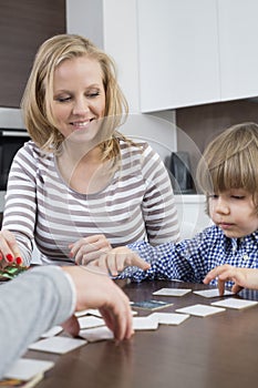 Boy playing cards with parents at home