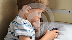 Boy playing cellphone games in train