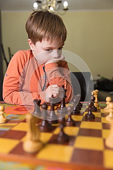 Boy playing chess at home