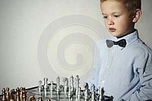 Boy playing chess.Smart kid.Little genius Child. Intelligent game.Chessboard