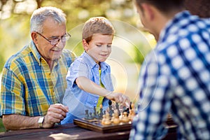 Boy playing chess on the table