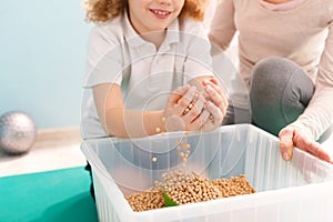 Boy playing with chickpeas