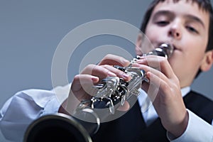 Boy playing on the clarinet