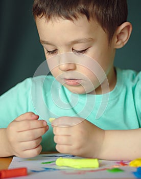 Boy playing with color play dough