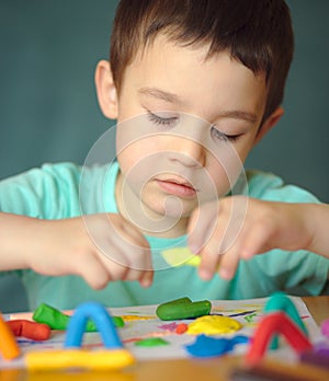 Boy playing with color play dough