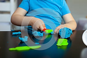 Boy playing with colorful clay molding in your room