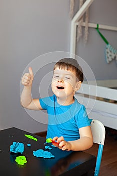 Boy playing with colorful clay molding in your room