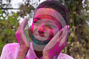 Boy playing with colors, In a happy mood. Concept for Indian festival Holi