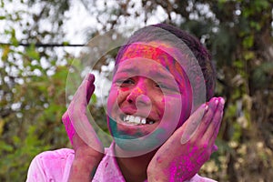 Boy playing with colors, In a happy mood. Concept for Indian festival Holi