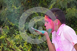 Boy playing with colors, In a happy mood. Concept for Indian festival Holi