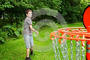 Boy playing disc golf