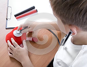 Boy playing doctor with stethoscope photo