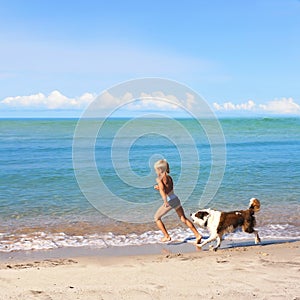 Boy playing dog on a sea coast