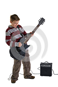 Boy playing an electric guitar isolated