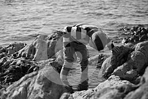 Boy Playing and Exploring in Tidal Pools Near the Ocean