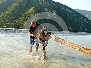Boy playing in Fella river, Northeast Italy photo