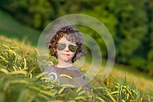 Boy playing on the filed in sunset, Thumbs up!