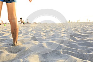 Boy playing football on the beach