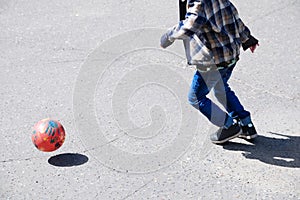 Boy playing football, child run with ball on asphalt, soccer team player, training outdoor, active lifestyle
