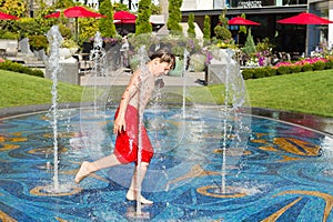 Boy playing in the fountain