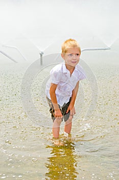 Boy playing in the fountain