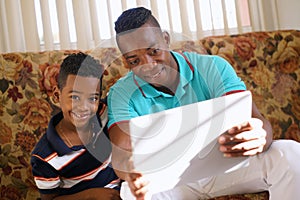 Boy Playing Game With Father On Laptop Pc