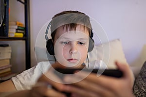 Boy playing game on smartphone