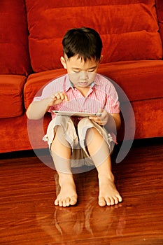 Boy playing game on tablet attentively