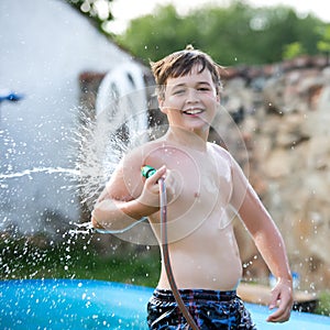 Boy playing with garden hose