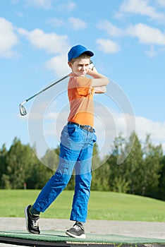 Boy playing golf in summer