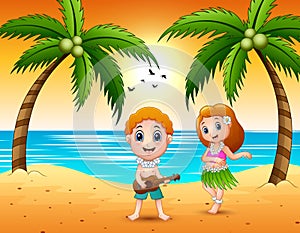 Boy playing guitar and hawaiian girl hula dancing at the beach