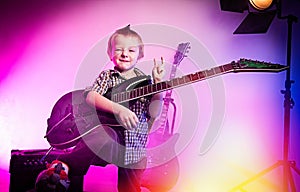 Boy playing guitar , kid guitarist .