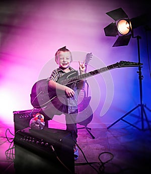 Boy playing guitar , kid guitarist .