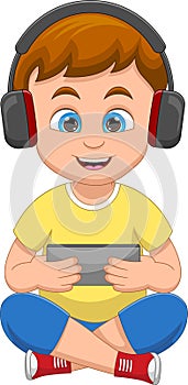 boy playing with hand phone and wearing headphones