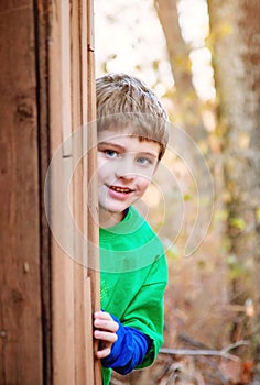 Boy playing hide and seek