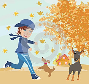 Boy playing with his dogs in autumn
