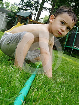 Boy playing with hose