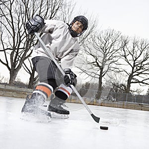 Boy playing ice hockey.