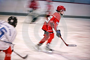 Boy playing ice hockey on the rink